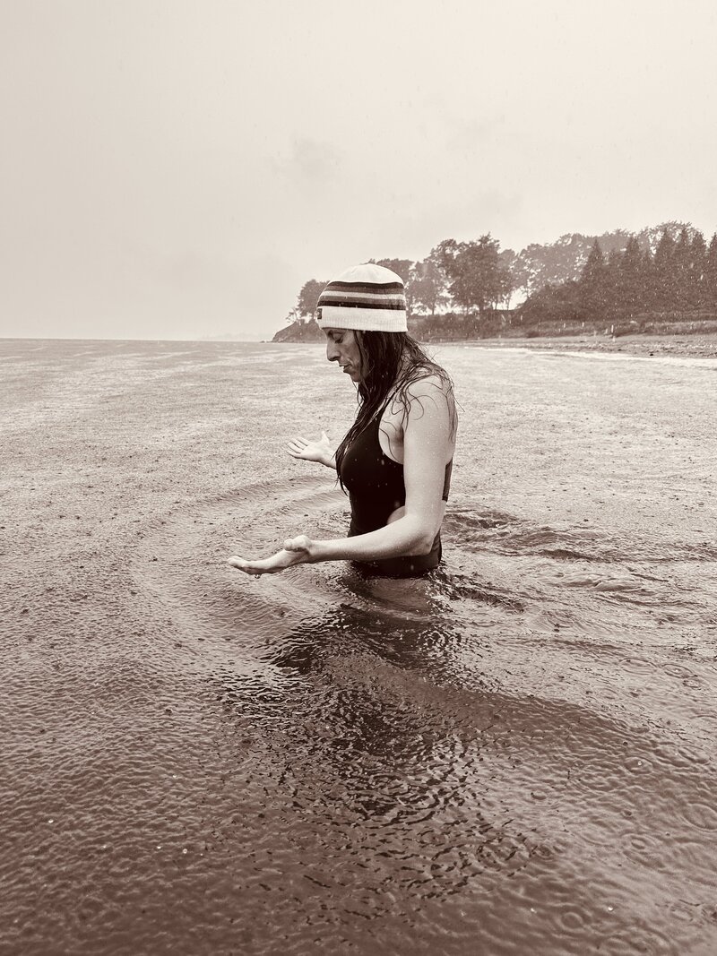 Deb Lauren in a meditative moment in the ocean and rain