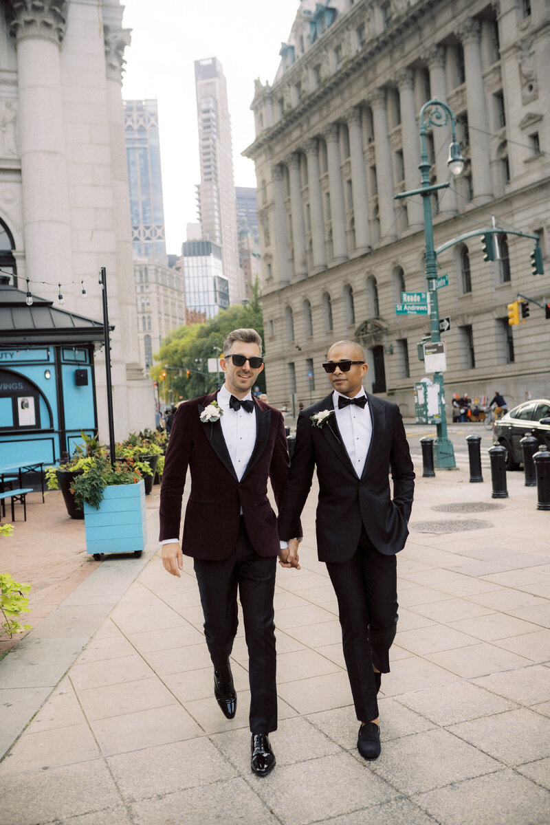 Grooms walking through street in tux with sunglasses on captured by Los Angeles wedding photographer Georgia Sheridan