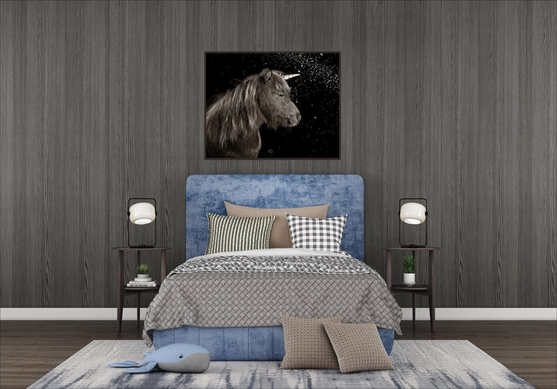 A bedroom with blue and brown tones and a wall art frame of a pony with a unicorn horn hanging over the bed