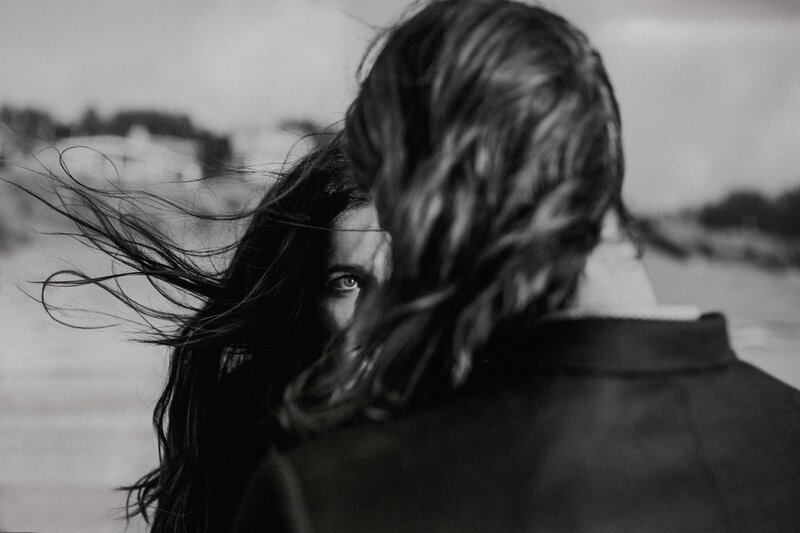 Close up of a wedding couple snuggling underneath a cathedral wedding veil