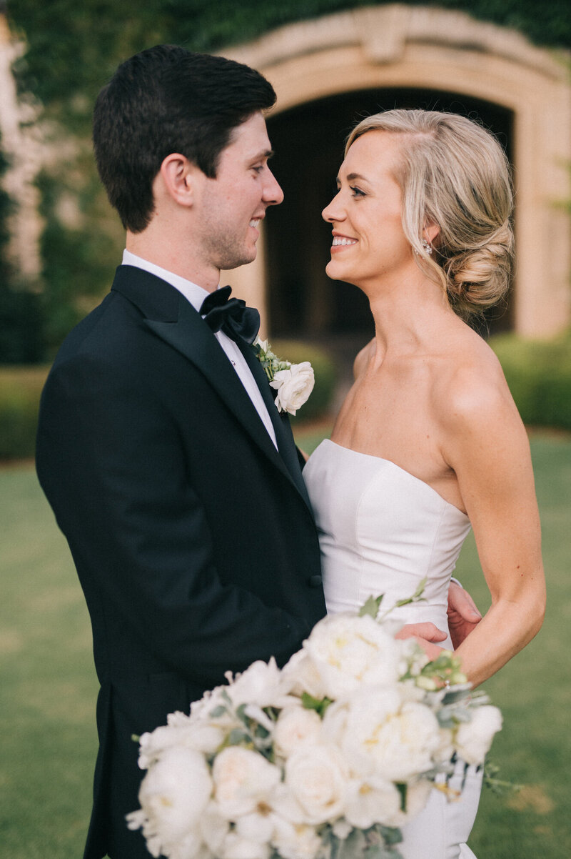 A bride and groom facing each other at Oklahoma Golf and Country Club