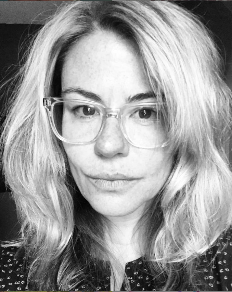 A black and white headshot of Licia Morelli in glasses
