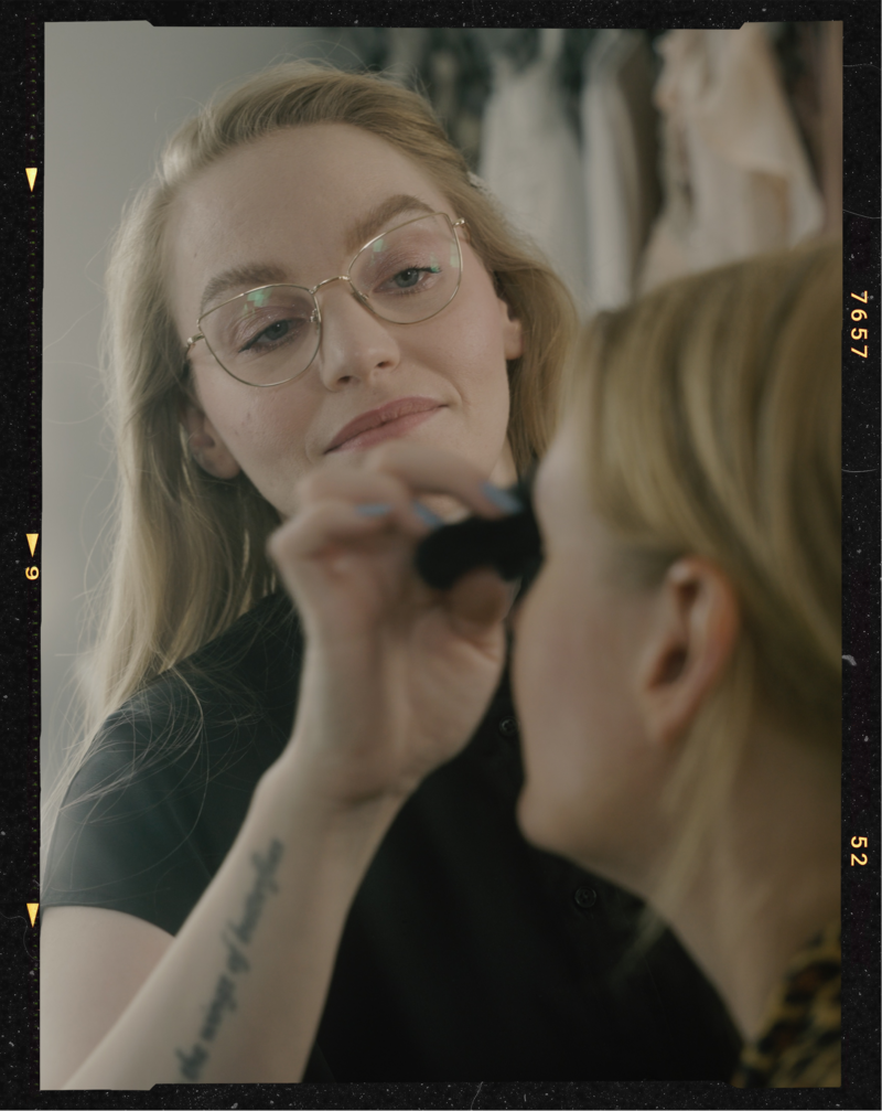 Behind the scenes photo of an empowering portrait session of a woman in a yellow suit in Helena Kristianssons Stockholm Studio