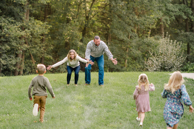 Three children running to their parents in their backyard near York, Pennsylvania