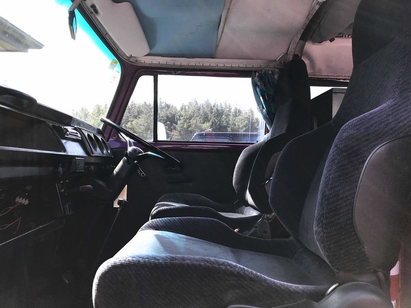 View of drivers and passengers seating of Pippi, purple retro kombi van from NZ Kombi Hire