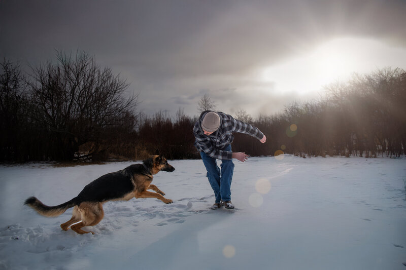 A German Shepherd and her owner play in the light of golden hour during a photoshoot. 
Work by Duluth-based pet photographer Joanna of Paddle Paws Photography.