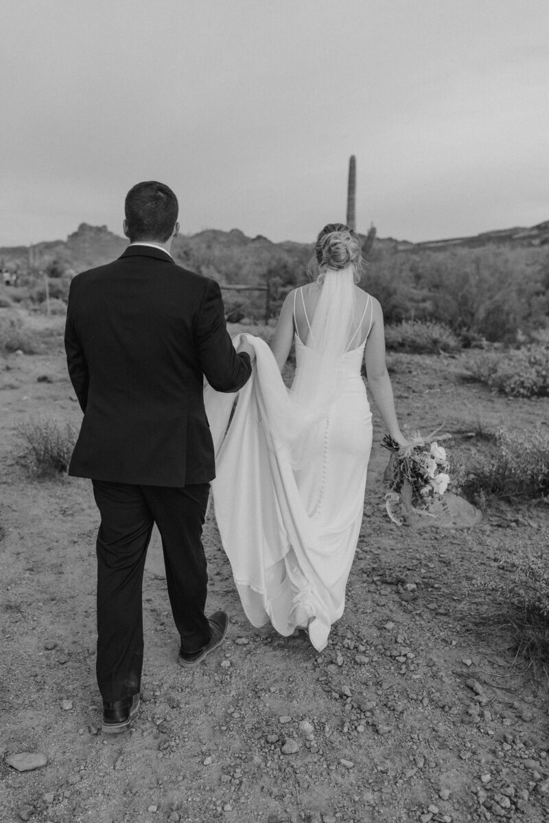 couple walking through the arizona desert on their wedding day