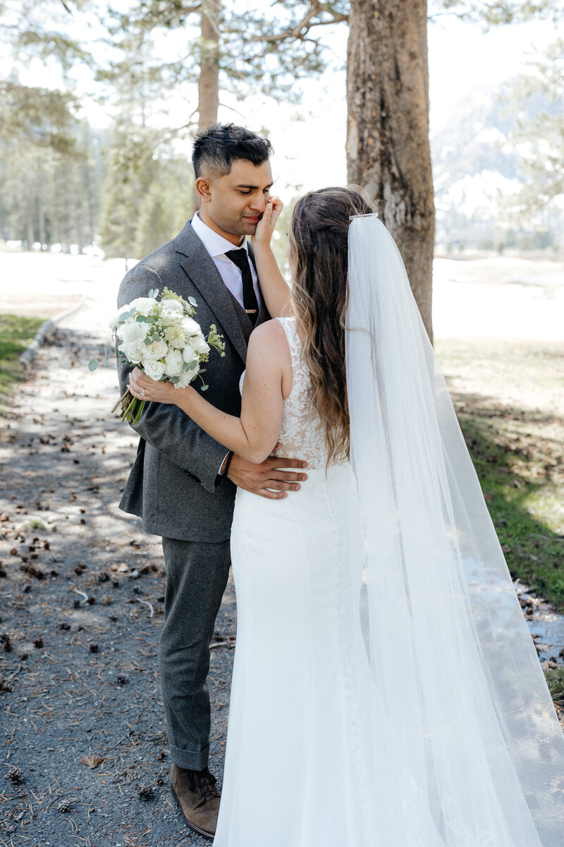 Wedding and Elopement Photographer, woman fanning herself in robe standing in a doorway