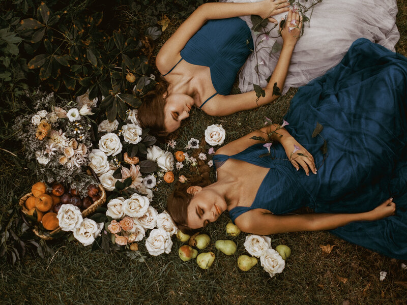 Midsummer inspired photoshoot with flowers and fruit laying in the grass