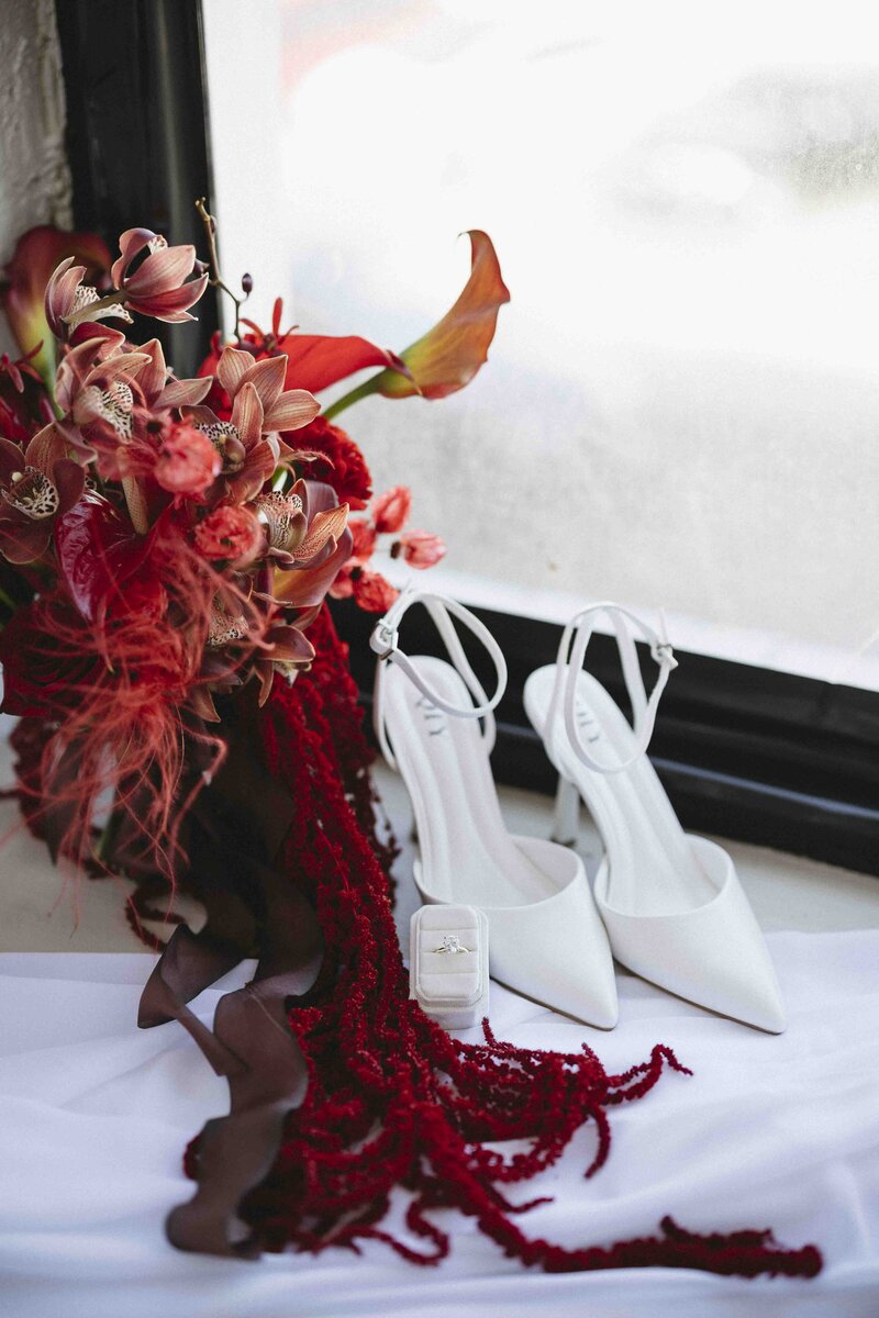 Bride's shoes, red florals, and ring box details