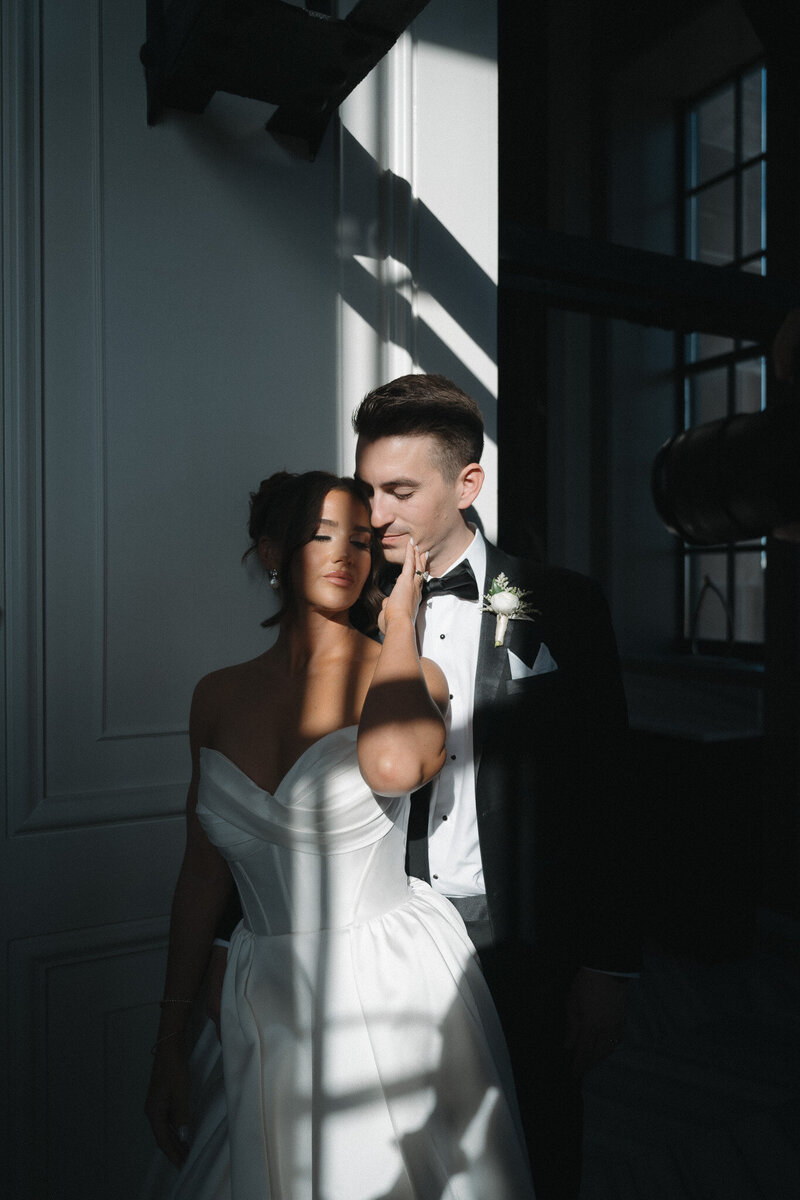 Bride and groom intimate moment with sun rays on their skin