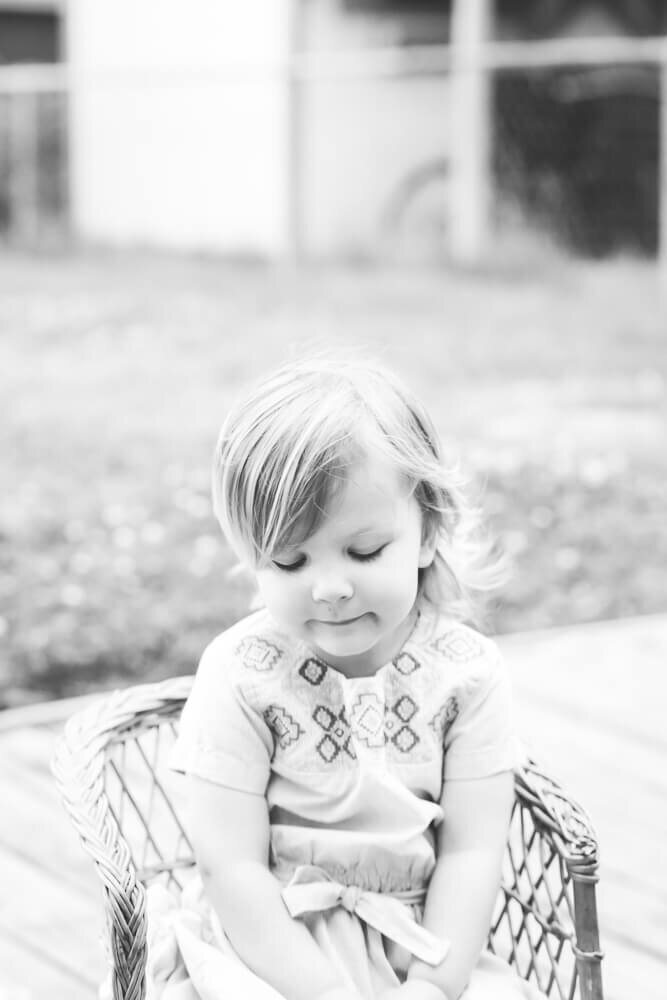 black and white photo of a toddler playing with toys