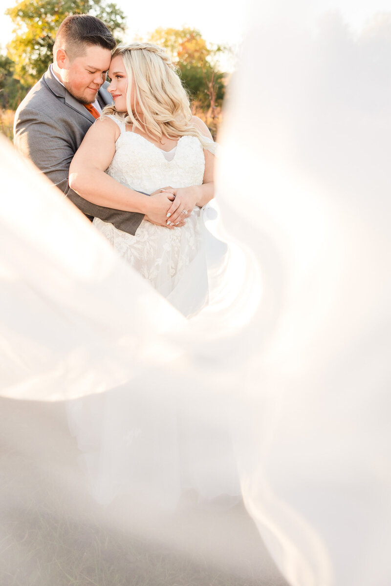 Bride and groom embrace at Funks Grove in Mclean, Illinois.