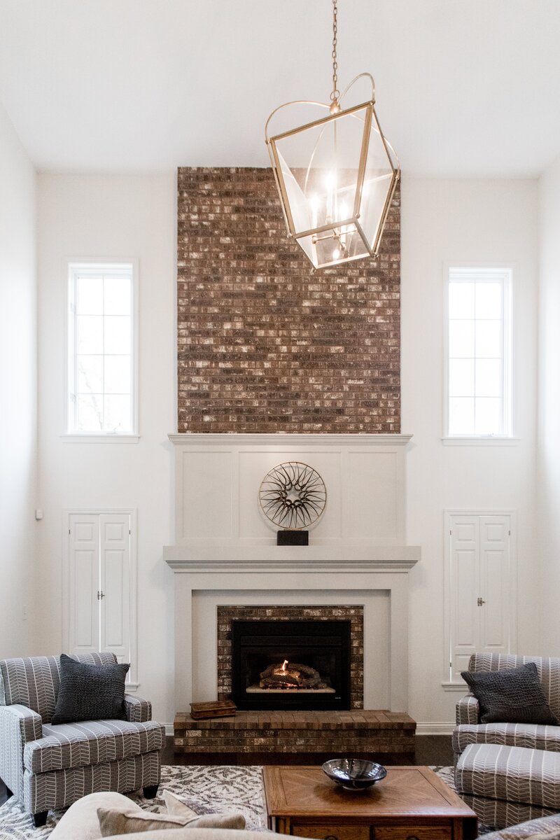 Custom Home Design in Minnesota High Ceiling Living Room with Brick Fireplace