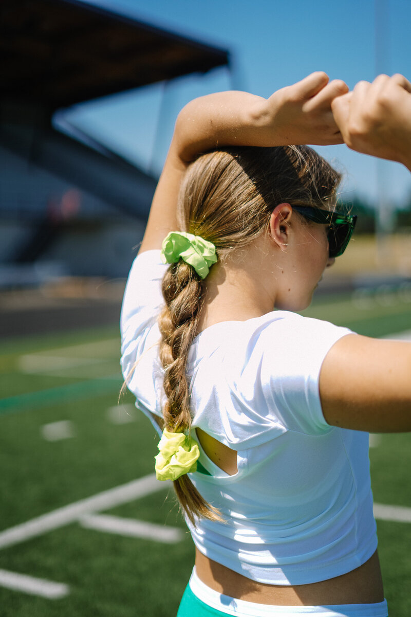 Girl athlete contemplating while stretching