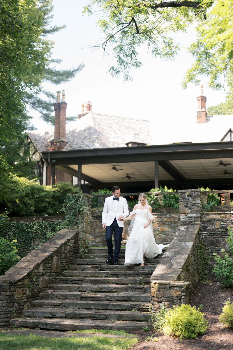 photo of bride and groom walking down the stairs at Magnolia Hill Farm taken by Cleveland OH wedding photographer, Kristin Leanne