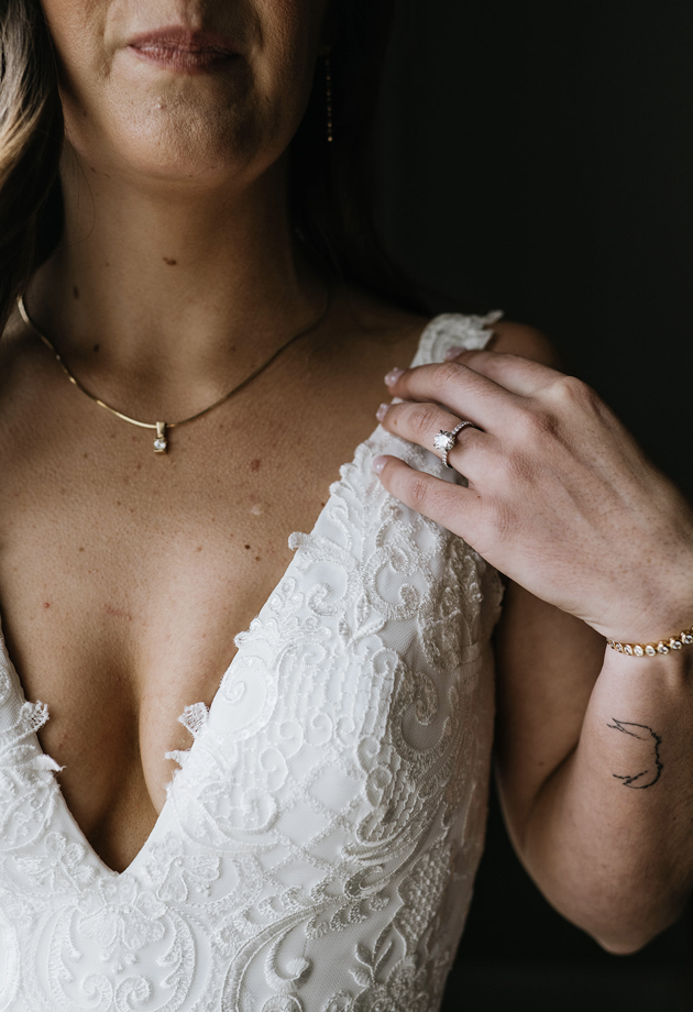 Close up of a bride with her left hand on her shoulder