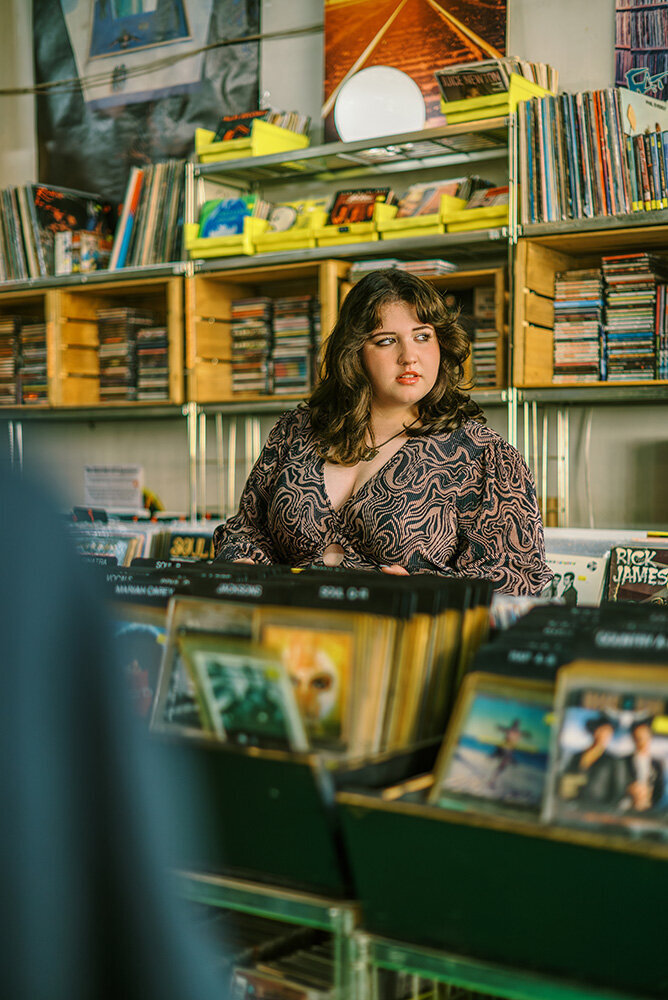 70s inspired senior portraits in a record store by Chicago senior photographer Kristen Hazelton