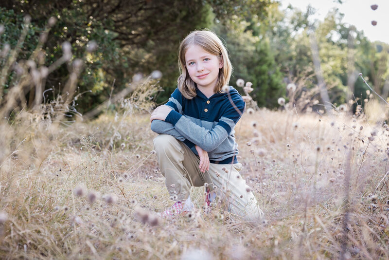 boy kneeling in the grass