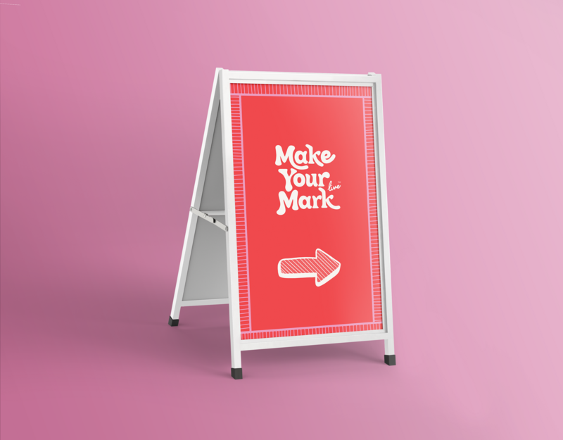 Custom branded a-frame signage with red background, hand-drawn typography on a pink seamless backdrop