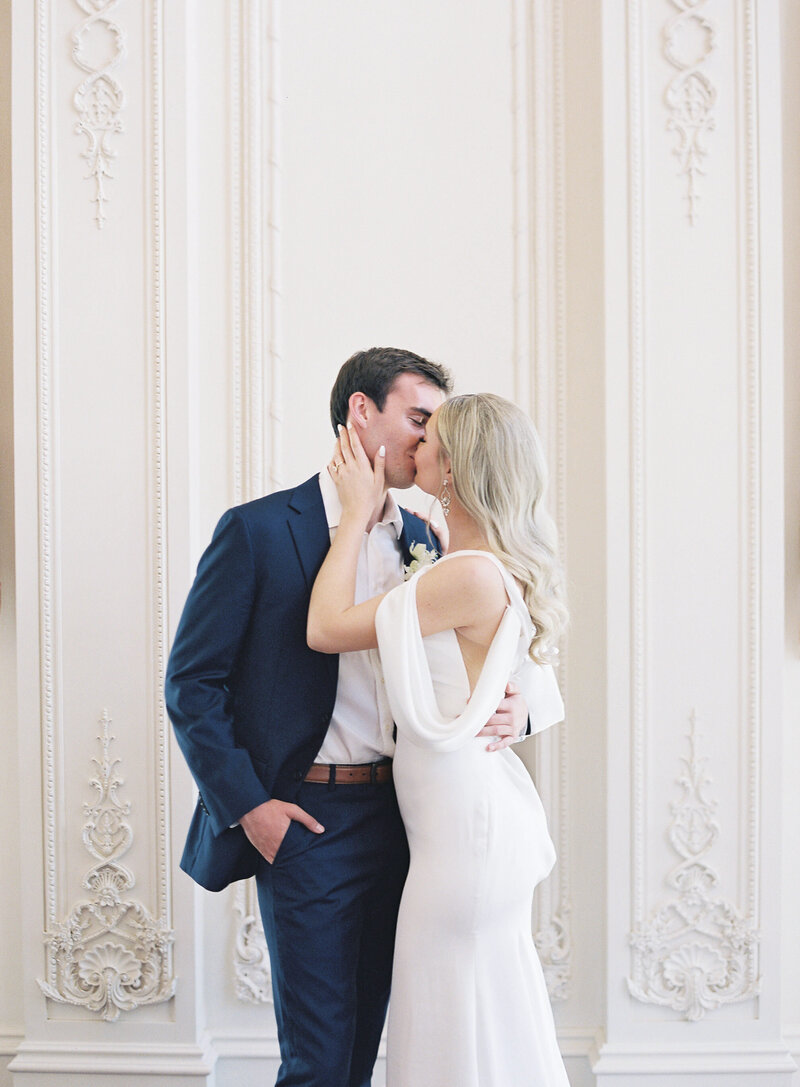 Bride and groom share a romantic kiss during their estate wedding in Richmond, Virginia, captured in a fine art editorial style.