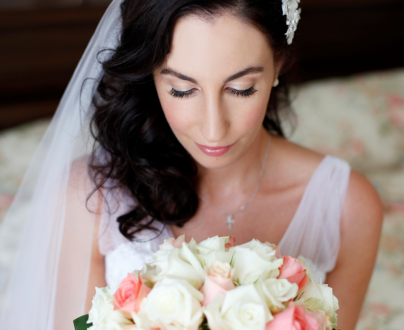 mother doing up bride's wedding dress