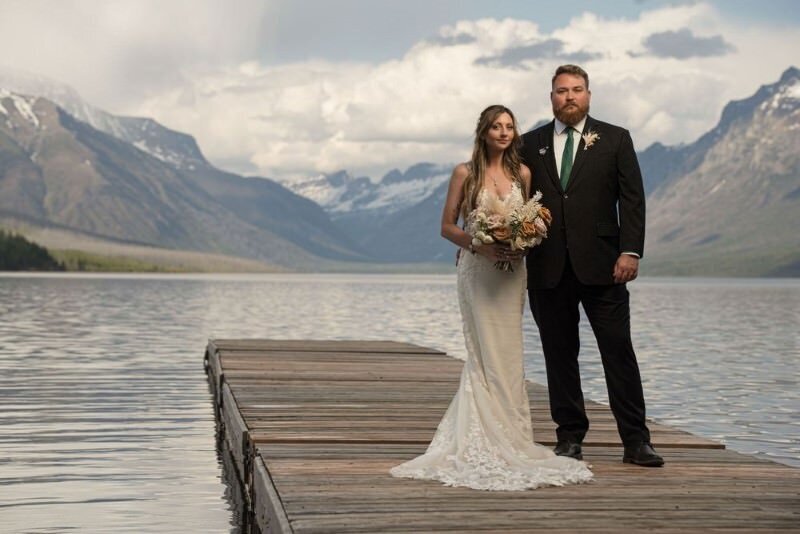 bride and groom on the dock in Apgar Village in Glacier National Park