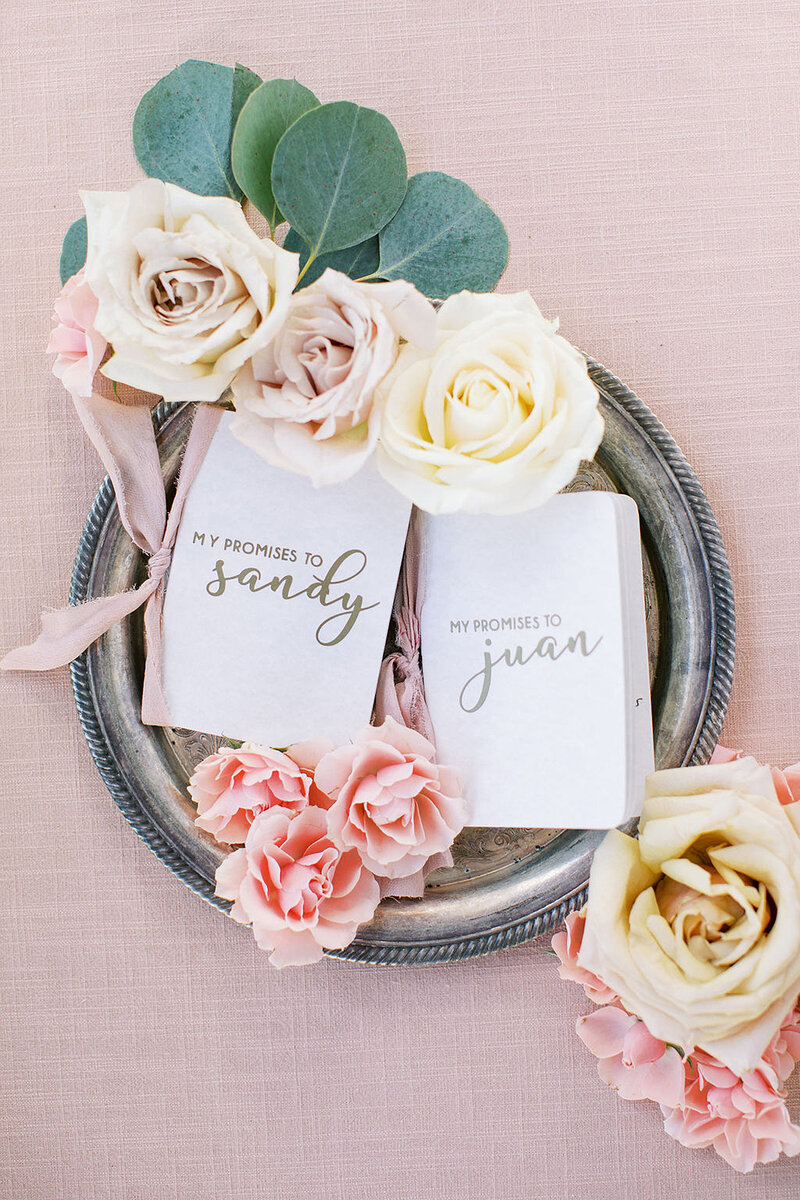 3-radiant-love-events-flatlay-antique-silver-tray-with-promise-bride-groom-booklets-white-roses-pink-flowers-mauve-ribbon-romantic-elegant-timeless
