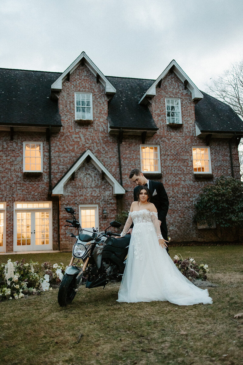 couple posing with motorcycle at Twickenham House in NC mountains