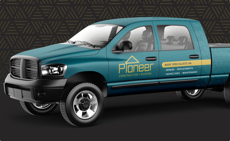 All teal pickup truck with the branding of Pioneer Construction and its services.