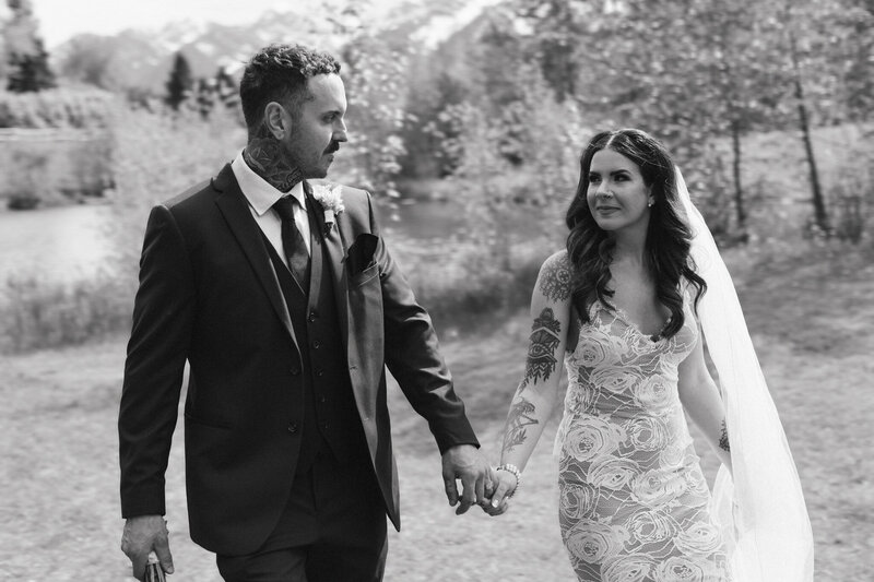 bride and groom hold hands during couples portraits at their cranbrook wedding
