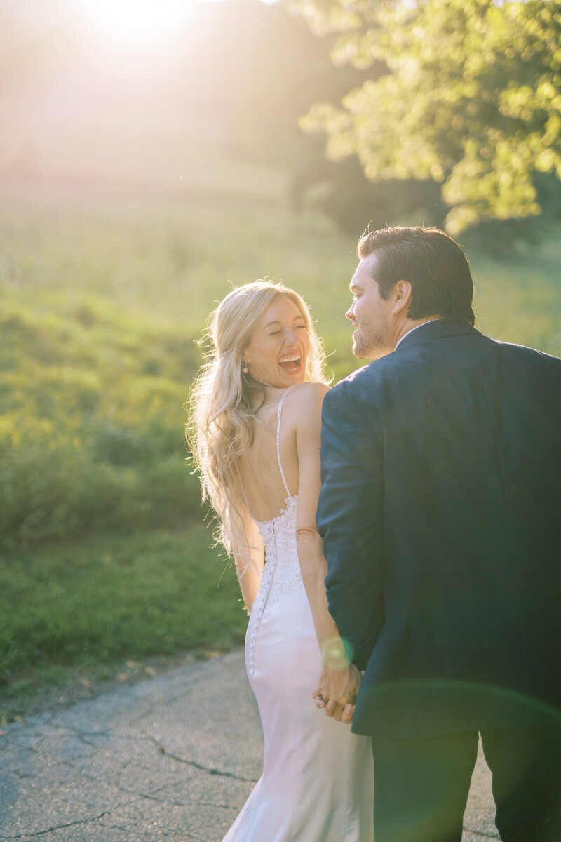 Bride laughs with Groom during portraits at sunset at Philander Chase Knox Estate wedding in Valley Forge, PA