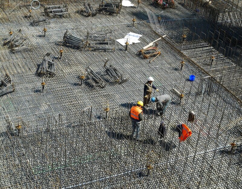 A construction site with construction staff standing