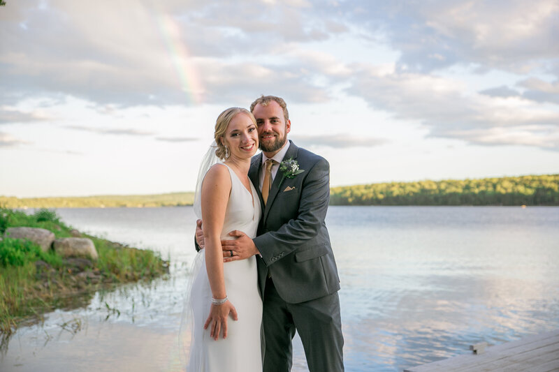 Bride and Groom with light rainbow in the back | Wedding Photography in Harmony, Maine