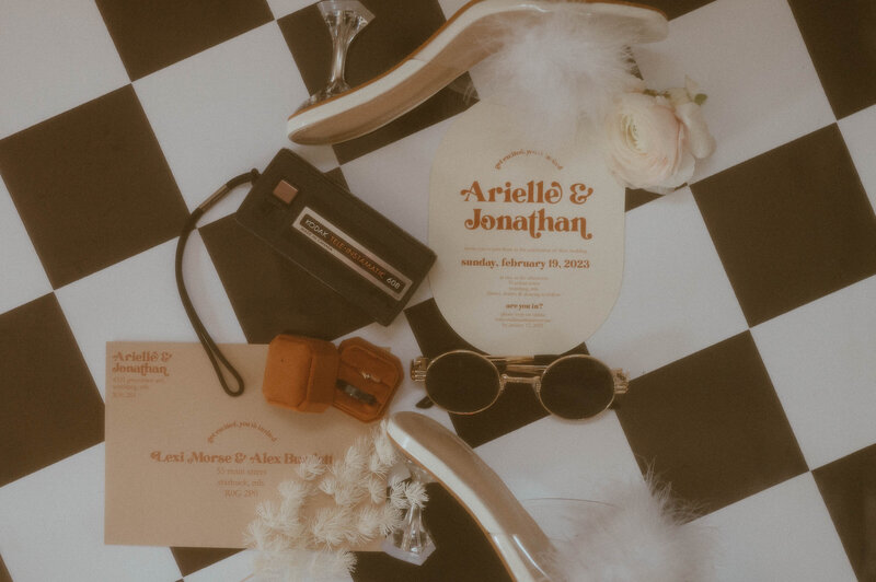 Vintage inspired wedding details including a film camera and sunglasses