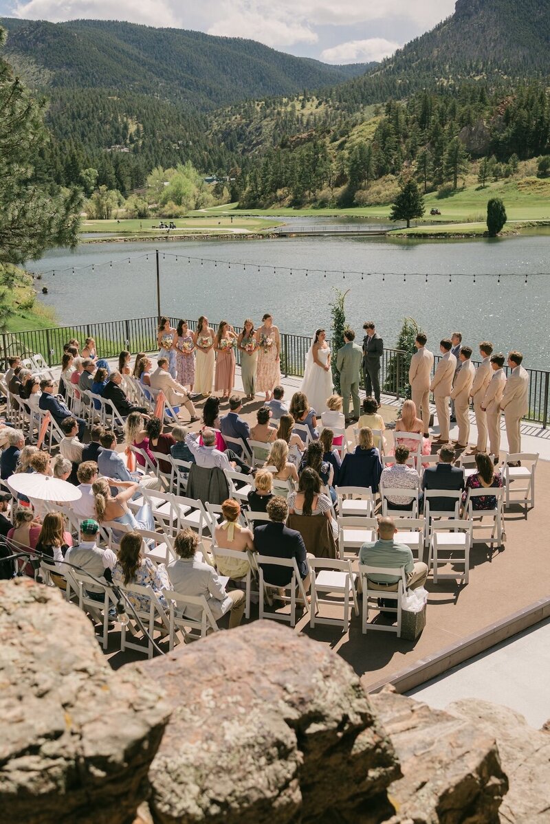 Outdoor lakeside wedding ceremony at Perry Park Country Club with Colorado mountain views