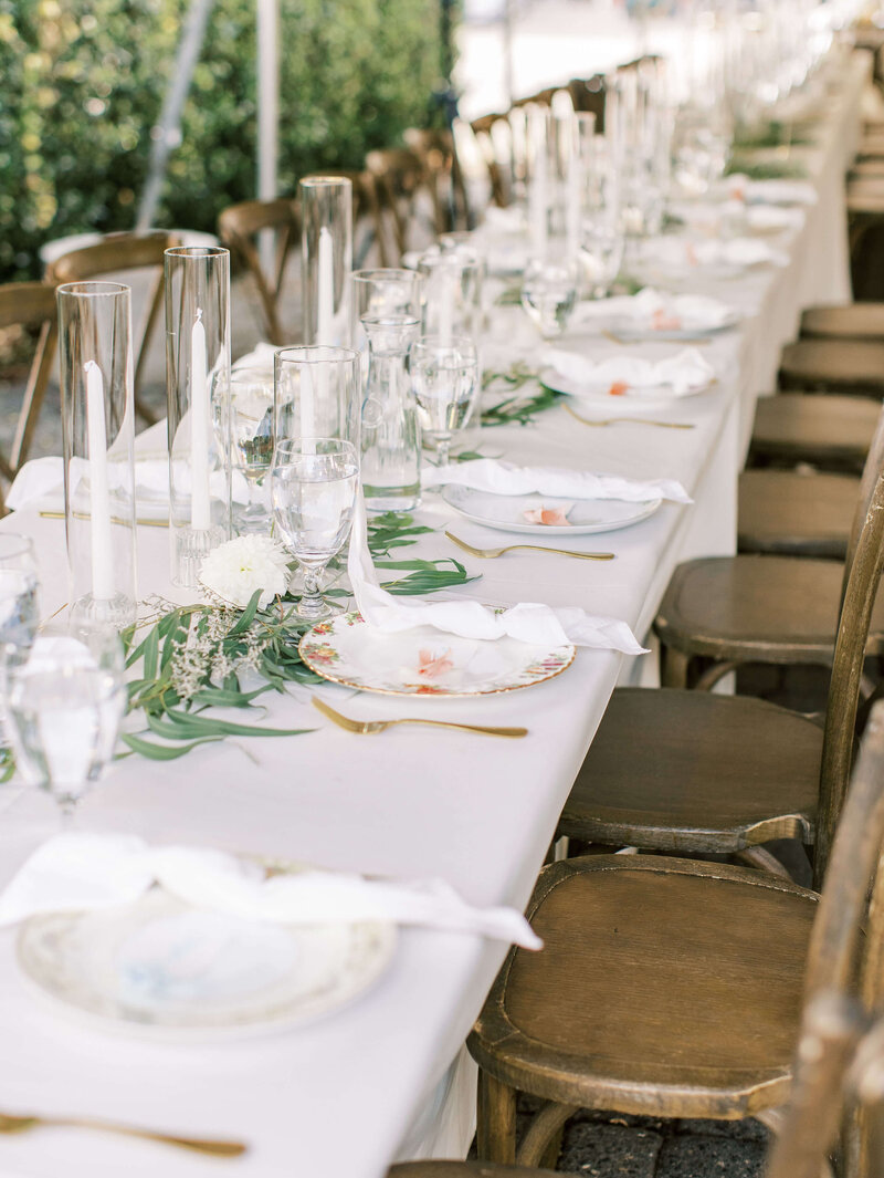 Luxury backyard wedding with candles, china, and guest name cards.