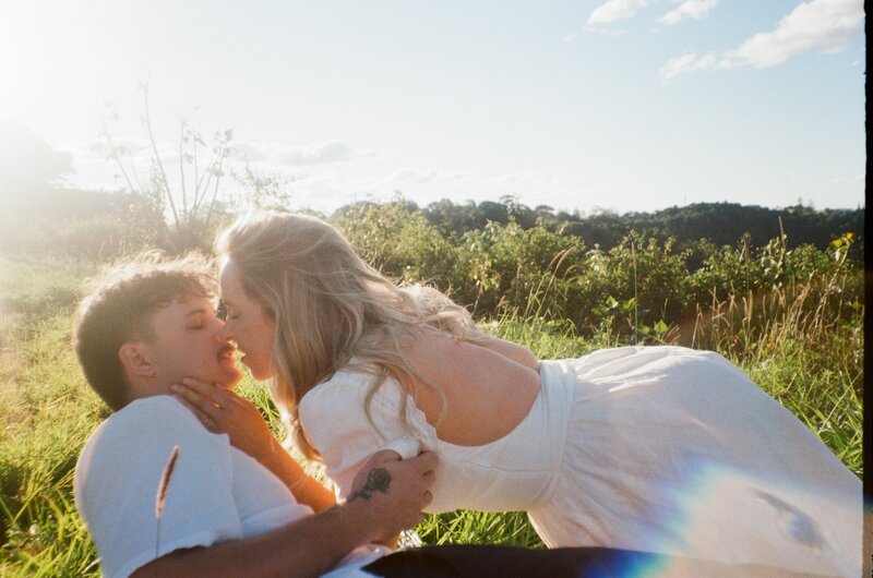 An engagement session photo of a young couple on film on the mountains of Maleny