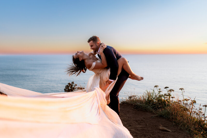 Couple dancing at sunset on a cliff overlooking the ocean, photographed by an Oregon Coast Elopement and Wedding Photographer.