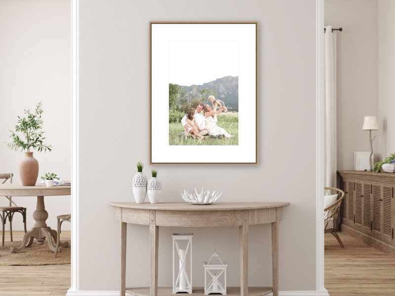 Large frame hanging above wooden table