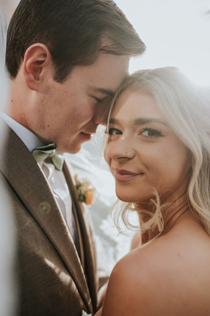 Bride and Groom snuggle and smile