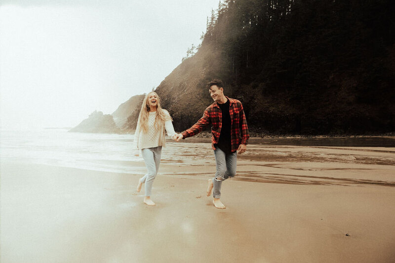 Couple holding hands and walking along the beach