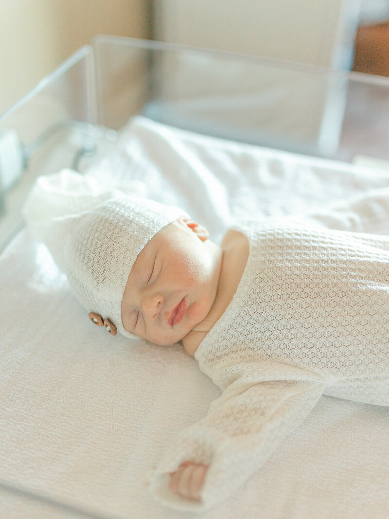 Newborn baby boy in hospital crib
