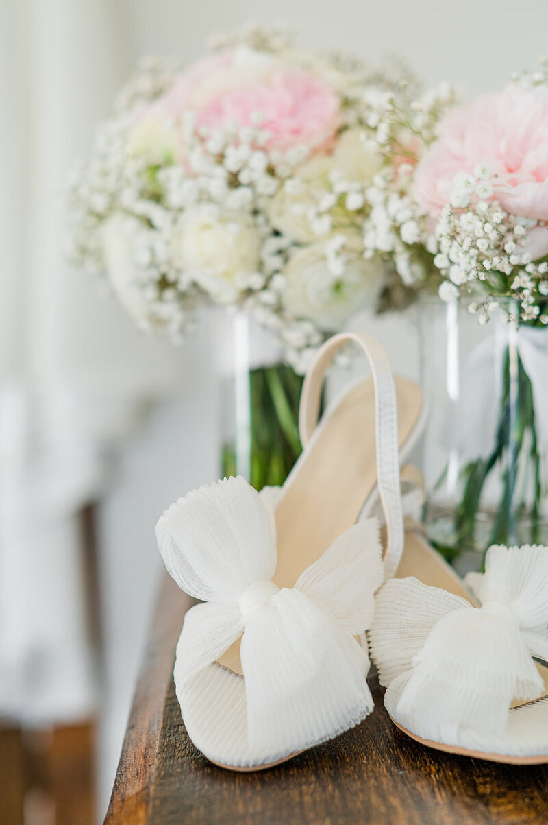 close up of white bridal shoes