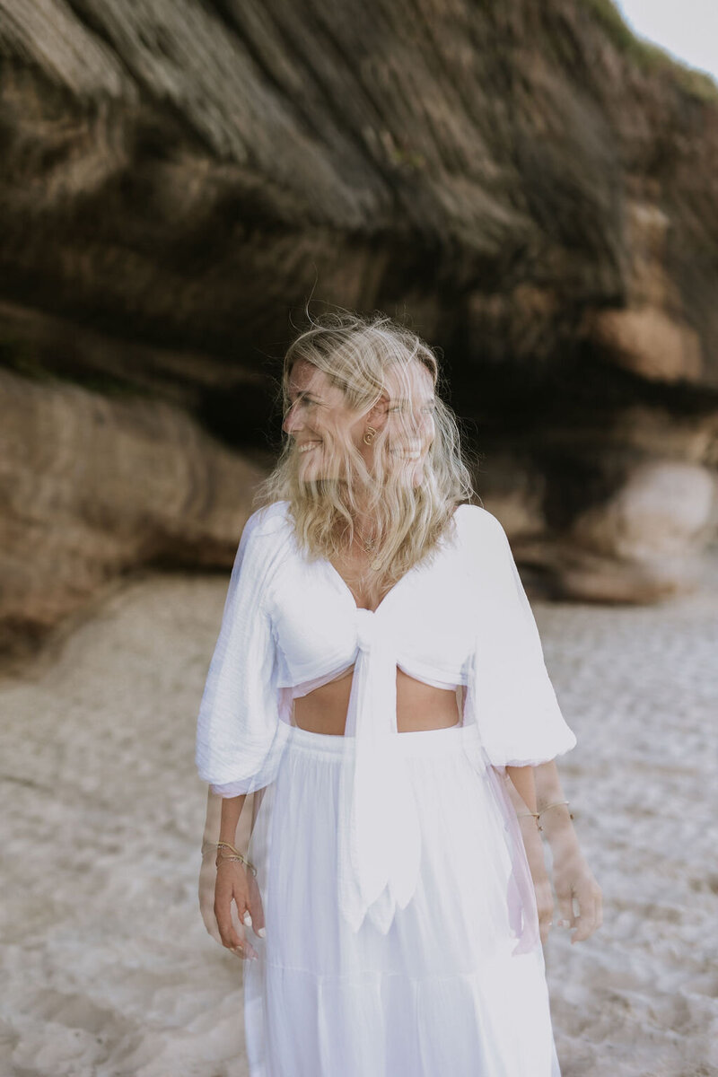 Blurry photo of woman on the beach dressed in white