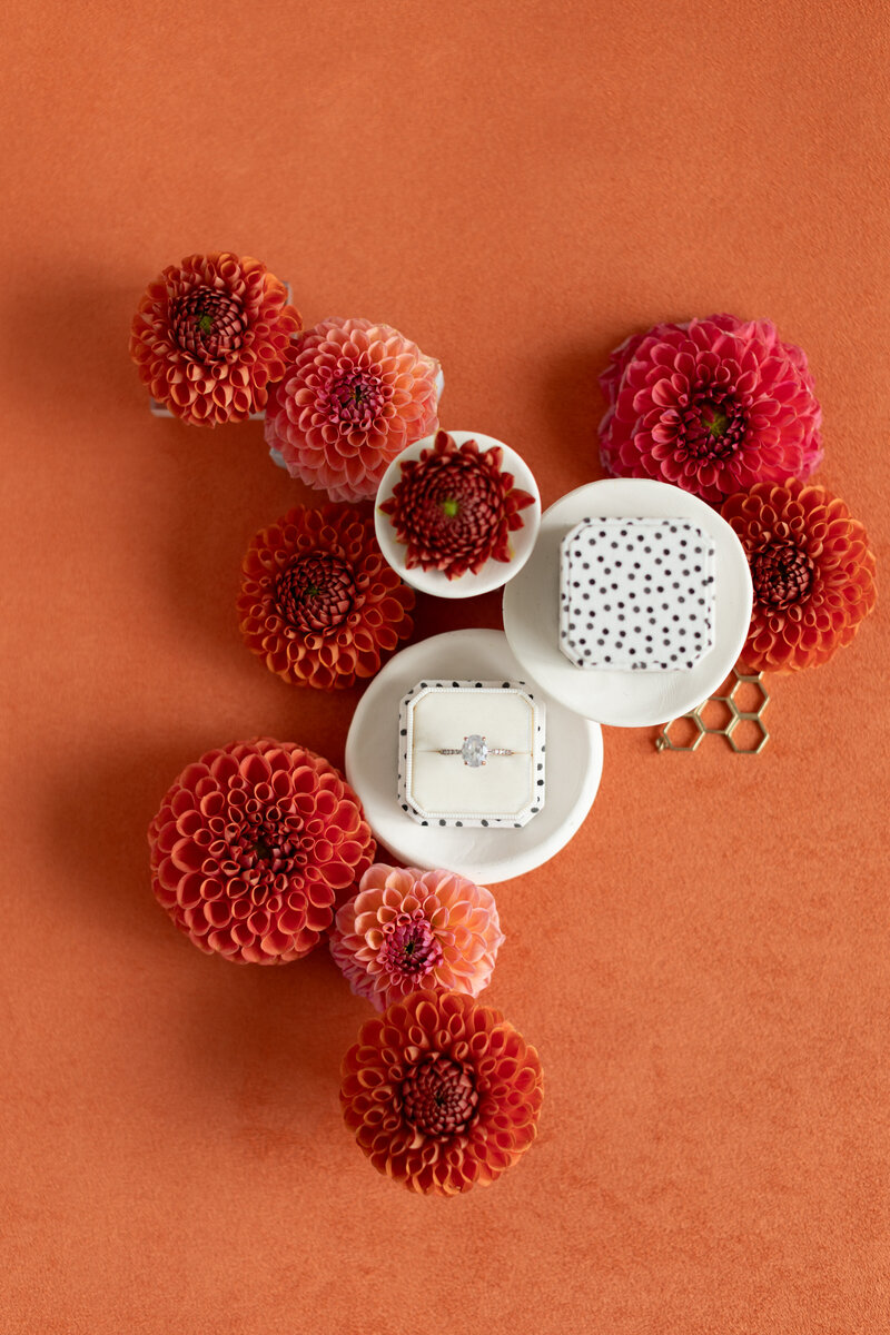 Orange suede mat with autumnal wedding stationery and golden accents