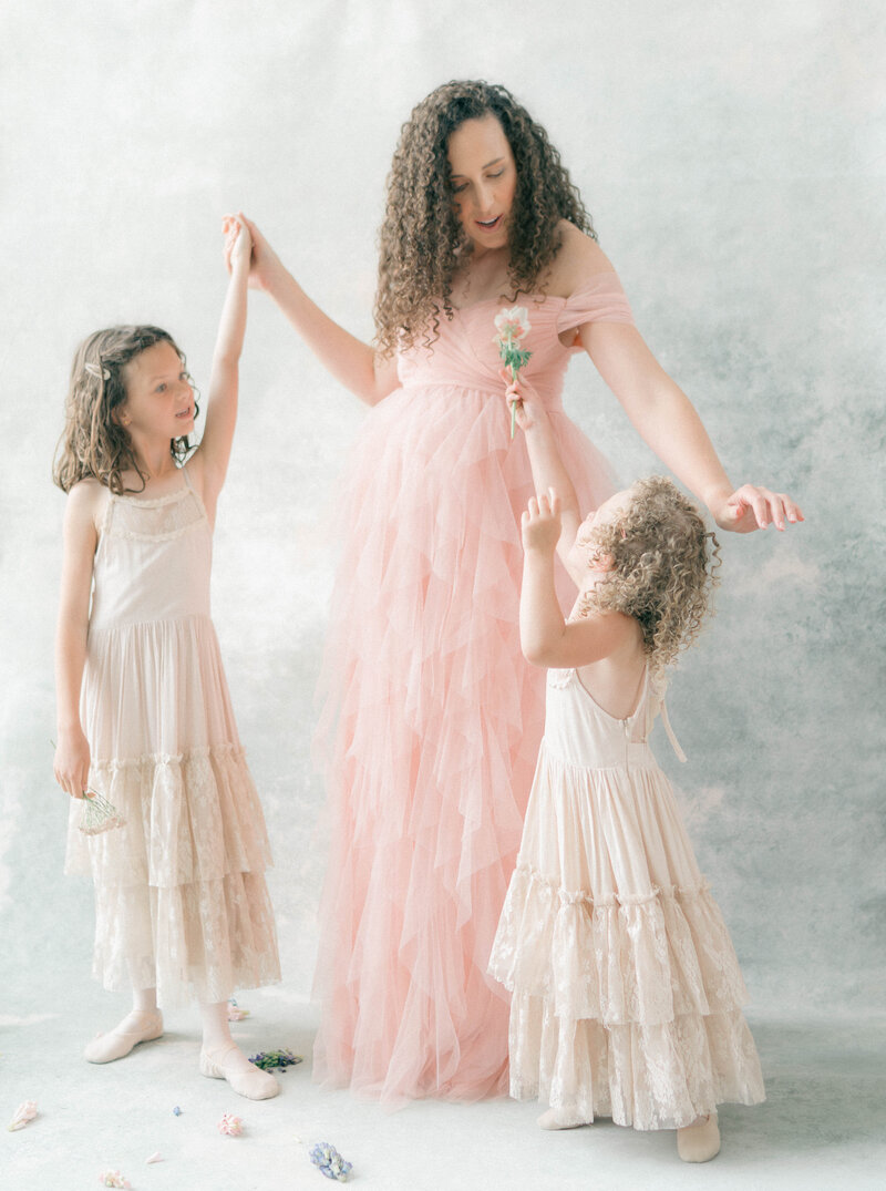 At-home maternity photoshoot in Riverton, Utah with a ballerina mom and her little ones.
