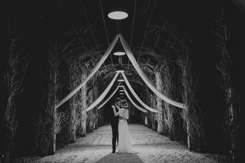 Romantic and natural night photograph of a couple under an arbour at Fernbank Farm on the NSW Central Coast, near the Hunter Valley