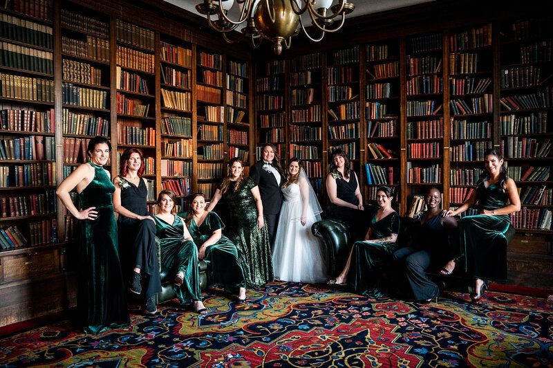 San Francisco wedding photographer captures wedding party in University Club's historic library with floor-to-ceiling bookshelves
