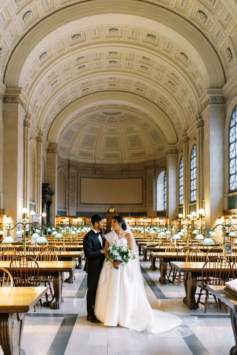 bride raises bouquet in excitement as she walks down aisle with her husband at Newport Wedding